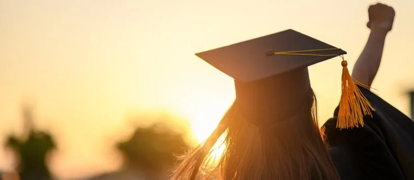Soma graduate wearing her cap & gown.